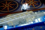 View taken from escalator approaching exhibit area, showing volunteer Paul Haas and the JFK model.
